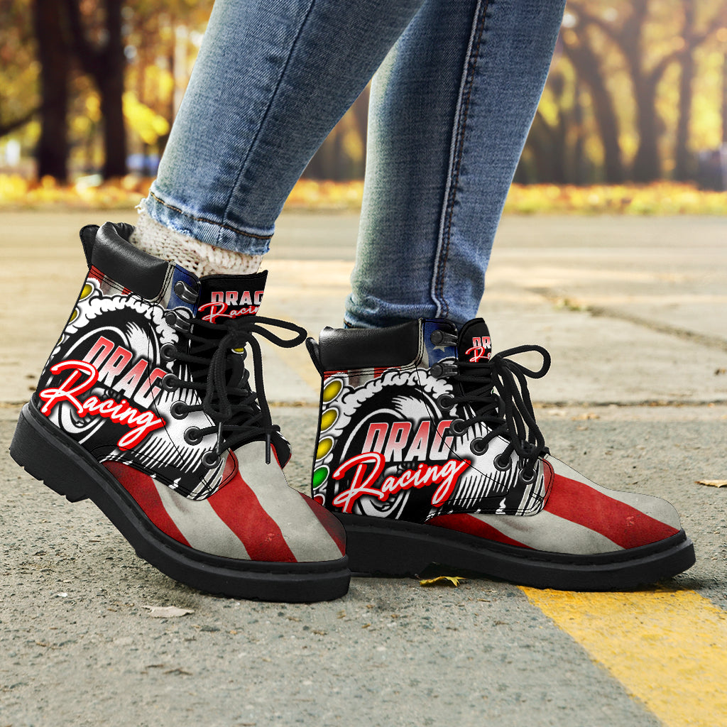 A pair of USA Drag Racing All-Season Boots featuring a bold, full-color drag racing design on high-quality water-resistant micro-suede with a heavy-duty black sole.