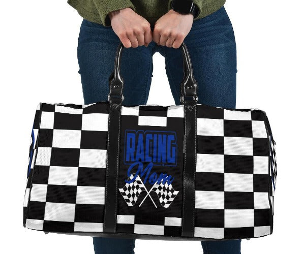 A stylish Racing Mom Travel Bag featuring a checkered flag pattern with the words "Racing Mom" and deep blue accents, carried by a model.