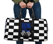 A stylish Racing Mom Travel Bag featuring a checkered flag pattern with the words "Racing Mom" and deep blue accents, carried by a model.