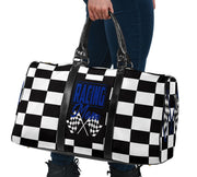 A stylish Racing Mom Travel Bag featuring a checkered flag pattern with the words "Racing Mom" and deep blue accents, carried by a model.