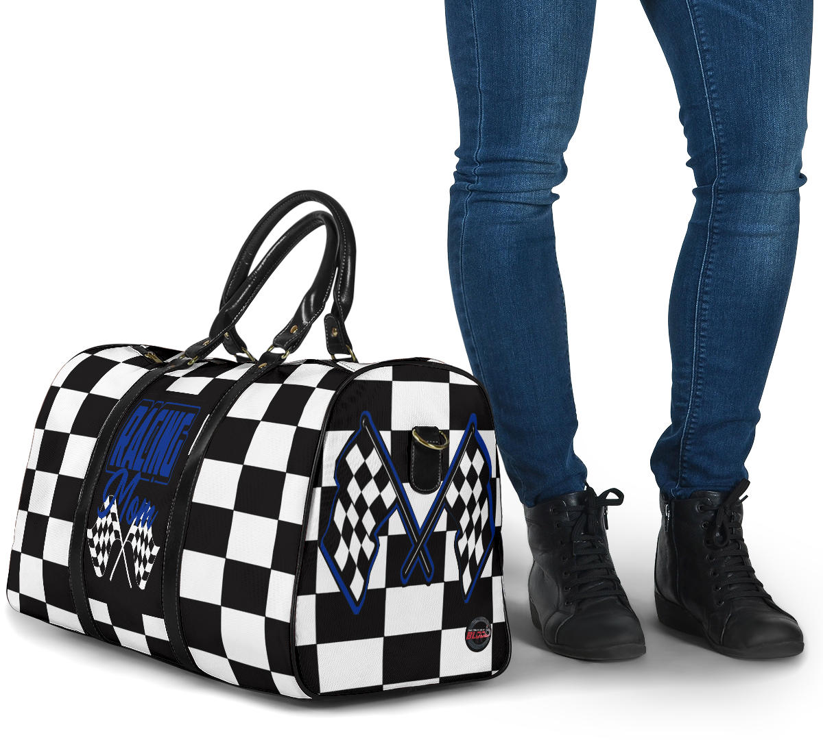 A stylish Racing Mom Travel Bag featuring a checkered flag pattern with the words "Racing Mom" and deep blue accents, carried by a model.
