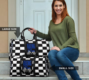 A stylish Racing Mom Travel Bag featuring a checkered flag pattern with the words "Racing Mom" and deep blue accents, carried by a model.