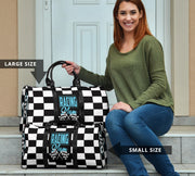 A stylish Racing Mom Travel Bag featuring a checkered flag pattern with the words "Racing Mom" and light blue accents, carried by a model.