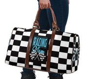 A stylish Racing Mom Travel Bag featuring a checkered flag pattern with the words "Racing Mom" and light blue accents, carried by a model.
