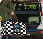 A stylish Racing Mom Travel Bag featuring a checkered flag pattern with the words "Racing Mom" and light blue accents, carried by a model.