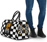A stylish Racing Mom Travel Bag featuring a checkered flag pattern with the words "Racing Mom" and vibrant orange accents, carried by a model.
