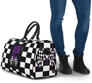 A stylish Racing Mom Travel Bag featuring a checkered flag pattern with the words "Racing Mom" and vibrant purple accents, carried by a model.