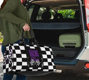 A stylish Racing Mom Travel Bag featuring a checkered flag pattern with the words "Racing Mom" and vibrant purple accents, carried by a model.