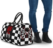 A stylish Racing Mom Travel Bag featuring a checkered flag pattern with the words "Racing Mom" and vibrant red accents, carried by a model.