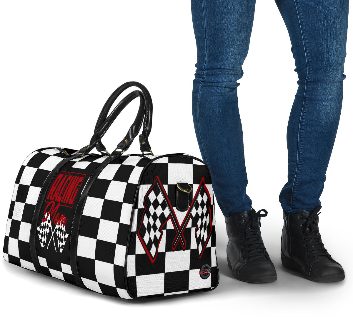A stylish Racing Mom Travel Bag featuring a checkered flag pattern with the words "Racing Mom" and vibrant red accents, carried by a model.