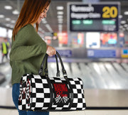 A stylish Racing Mom Travel Bag featuring a checkered flag pattern with the words "Racing Mom" and vibrant red accents, carried by a model.