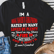 Bold racing t-shirt for women featuring the statement "I'm A Drag Racer's Girlfriend Hated By Many Loved By Plenty," available in v-necks, racerback tanks, and premium cotton tees.