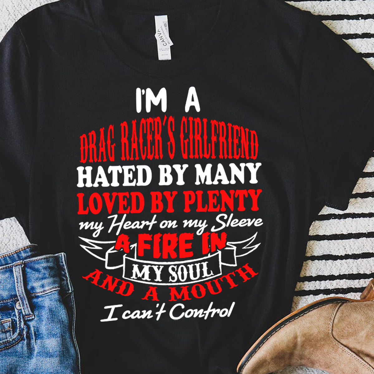 Bold racing t-shirt for women featuring the statement "I'm A Drag Racer's Girlfriend Hated By Many Loved By Plenty," available in v-necks, racerback tanks, and premium cotton tees.