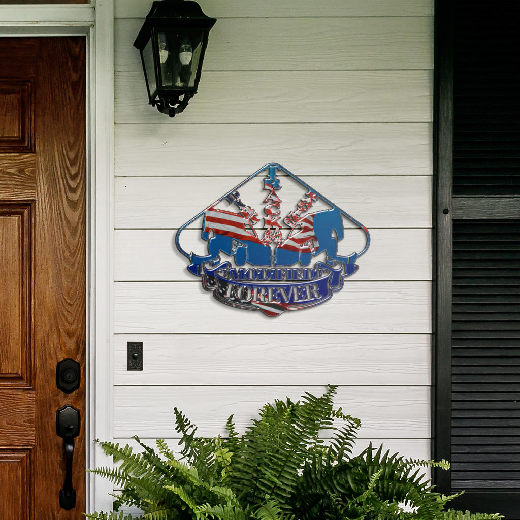 Dirt Modified Forever metal sign on white porch siding beside a wooden door and fern.