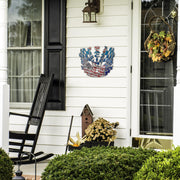 Dirt Track Racing Forever sign beside a front door, black rocking chair and seasonal plants.
