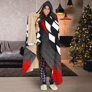 Woman wearing a Hooded blanket with drag racing design featuring checkered flags and colorful text.