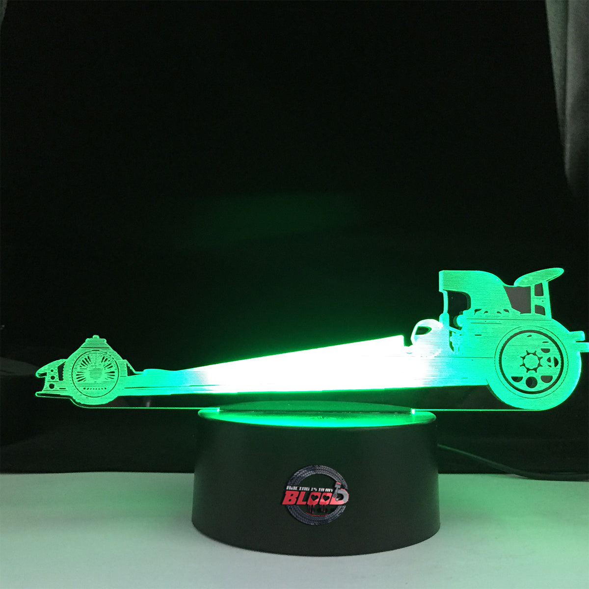 Dragster 3D LED Lamp showing a sleek Top Fuel dragster silhouette glowing in a bright, race-ready red on a modern black base.