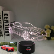 Ford Mustang 3D LED Illusion Lamp showing the iconic car silhouette in vibrant blue light on a black base.
