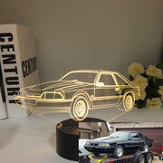 Ford Mustang LX 3D LED Illusion Lamp showing the classic Fox Body silhouette in a vibrant blue glow on a premium black base.