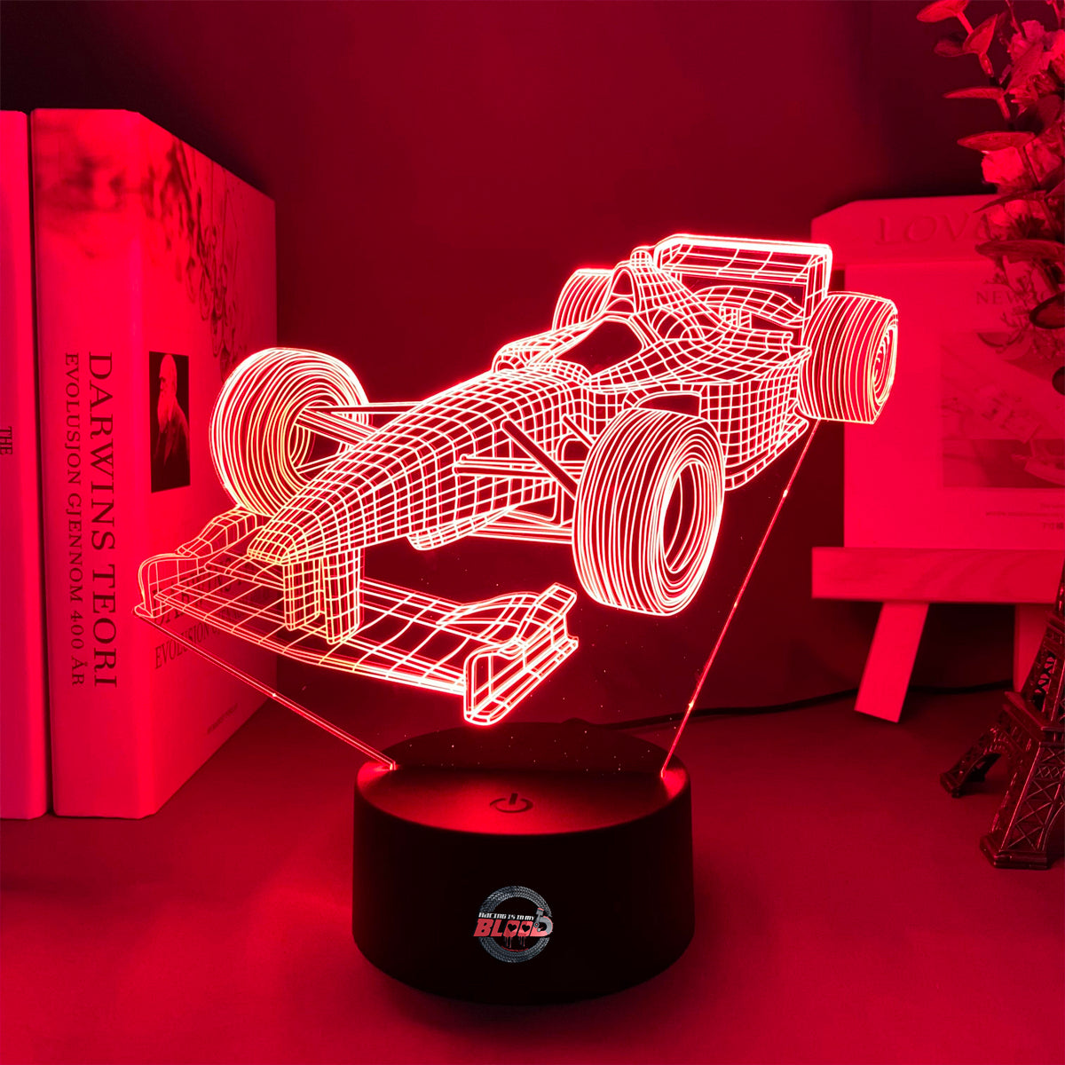 Formula One 3D LED Lamp featuring a sleek open-wheel racer silhouette glowing in a vibrant, racing purple on a modern black base.