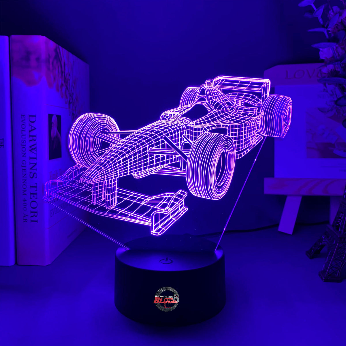 Formula One 3D LED Lamp featuring a sleek open-wheel racer silhouette glowing in a vibrant, racing purple on a modern black base.