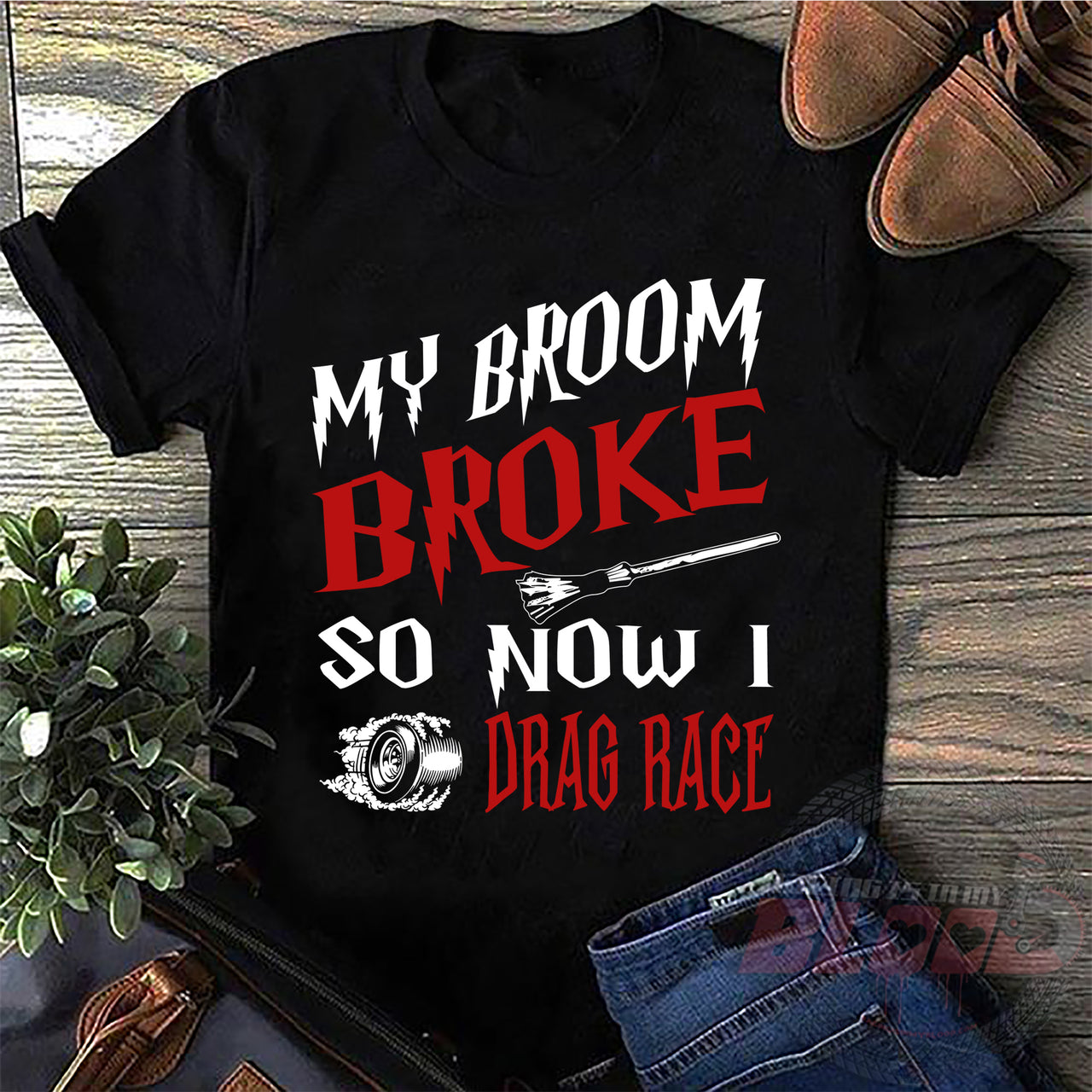 Funny drag racing apparel featuring the playful "My Broom Broke So Now I Drag Race" statement, available in premium women's and unisex t-shirts, tanks, and hoodies.