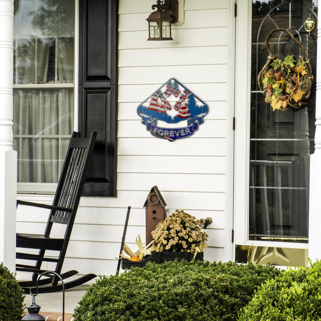 Go-Kart Forever sign beside a front door, black rocking chair and seasonal plants.