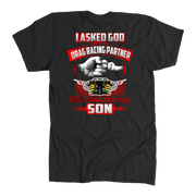 Heartfelt drag racing apparel featuring a fist-bump graphic and the text "I Asked God For A Drag Racing Partner He Sent Me My Son," available in t-shirts, tanks, and hoodies.