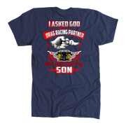 Heartfelt drag racing apparel featuring a fist-bump graphic and the text "I Asked God For A Drag Racing Partner He Sent Me My Son," available in t-shirts, tanks, and hoodies.