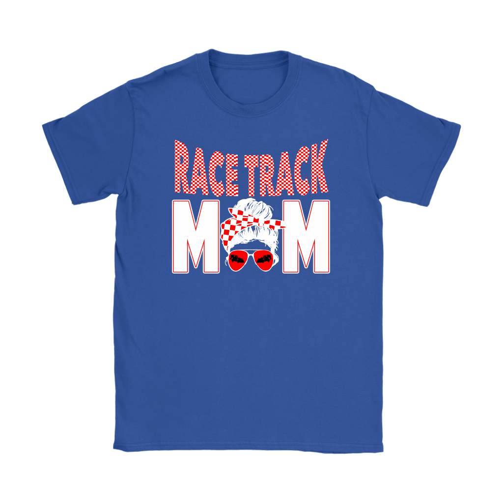 High-performance apparel mockup featuring a woman sitting on the grandstand bleachers at a dirt racing arena, wearing a premium black t-shirt with a sharp white and red "Race Track Mom" graphic showing a late model dirt car.