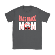 High-performance apparel mockup featuring a woman sitting on the grandstand bleachers at a dirt racing arena, wearing a premium black t-shirt with a sharp white and red "Race Track Mom" graphic showing a late model dirt car.