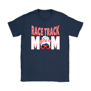 High-performance apparel mockup featuring a woman sitting on the grandstand bleachers at a dirt racing arena, wearing a premium black t-shirt with a sharp white and red "Race Track Mom" graphic showing a late model dirt car.