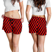 High-performance women's athletic shorts featuring a bold red and black checkered pattern, designed with an elastic drawstring waist and functional side pockets.