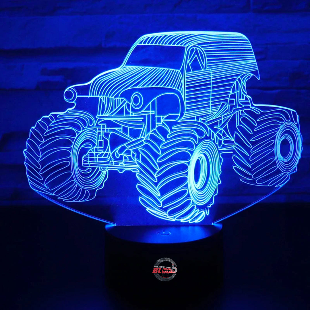 Monster Truck 3D LED Lamp showing a lifted truck silhouette with massive tires glowing in a vibrant, neon yellow on a black base.