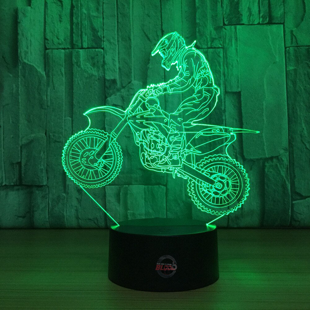 Motocross 3D LED Lamp showing a detailed dirt bike silhouette glowing in a bright neon blue on a modern black base.