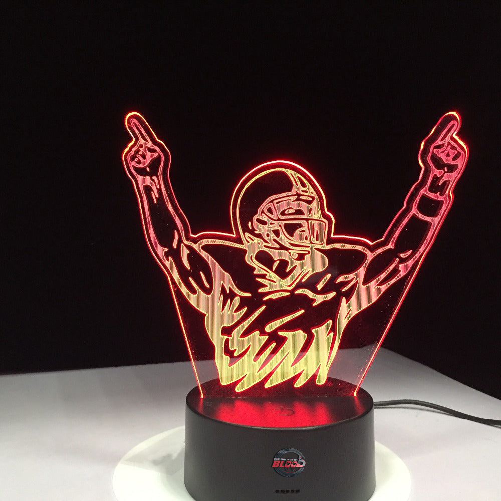 Motocross Champion 3D LED Lamp showing a detailed dirt bike rider jumping in mid-air, glowing in a vibrant orange on a modern black base.