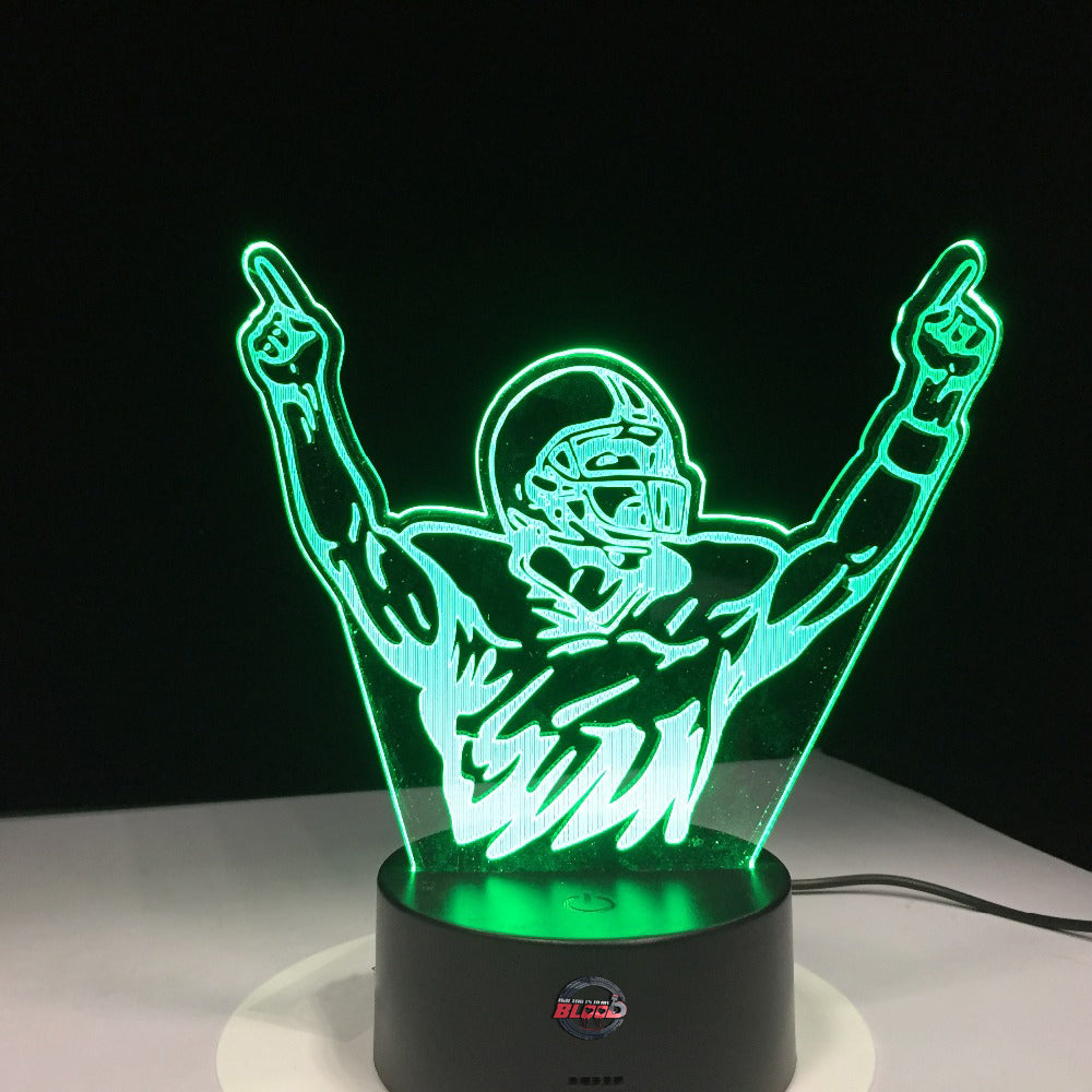 Motocross Champion 3D LED Lamp showing a detailed dirt bike rider jumping in mid-air, glowing in a vibrant orange on a modern black base.