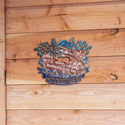 Motocross Forever metal sign with checkered flags and piston artwork against natural wood planks.
