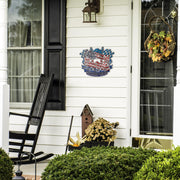 Motocross Forever sign beside a front door, black rocking chair and seasonal plants.