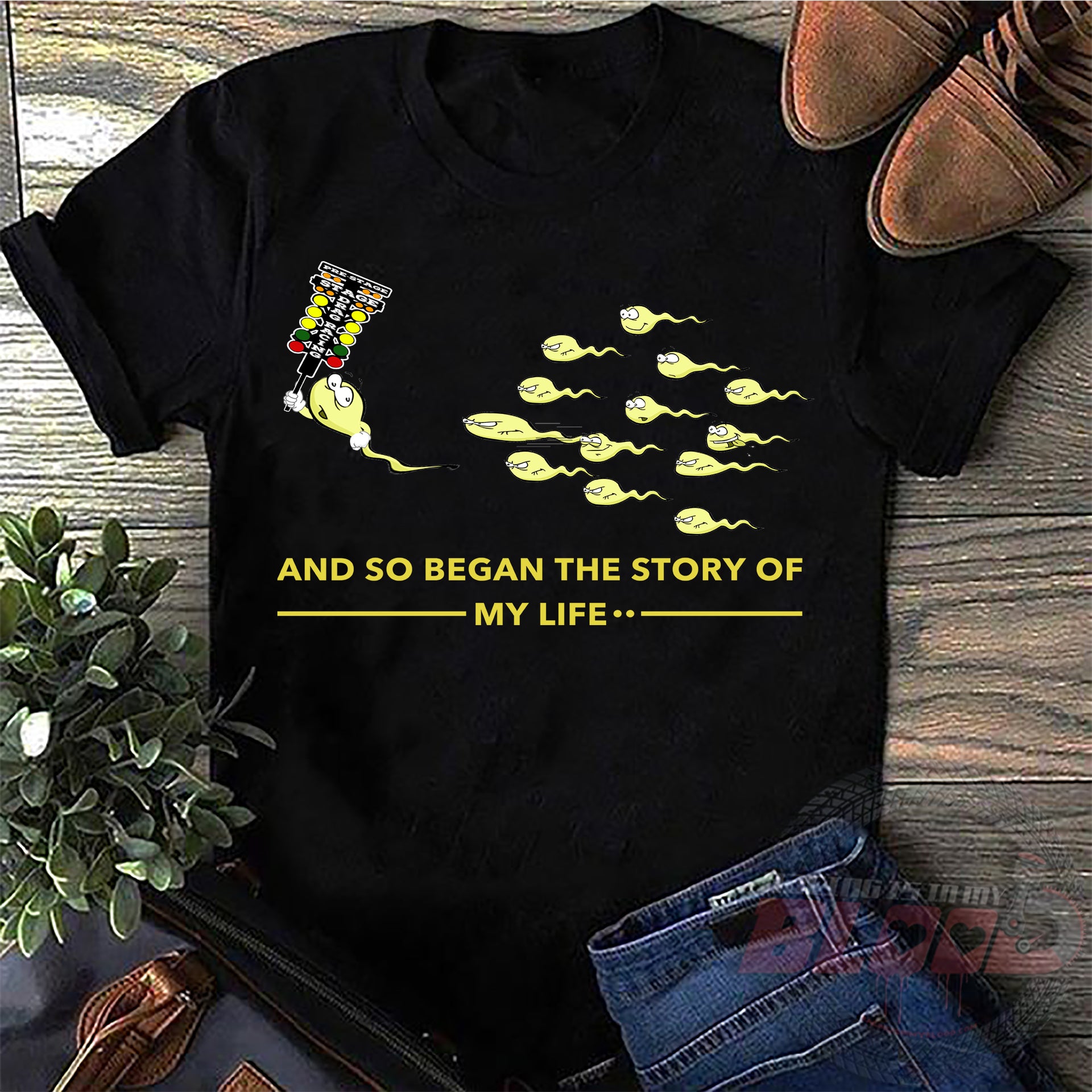 Motorsports apparel featuring the quote "And So Began The Story Of My Life Drag Racing", available in premium men's and women's t-shirts, tanks, and warm hoodies.