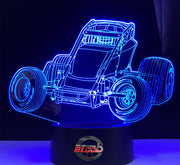 Non-Wing Sprint Car 3D LED Lamp featuring a detailed open-wheel dirt track racer silhouette glowing in a bright racing orange on a modern black base.