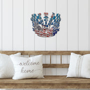 Patriotic dirt track racing sign mounted above a wooden bench with white cushions.