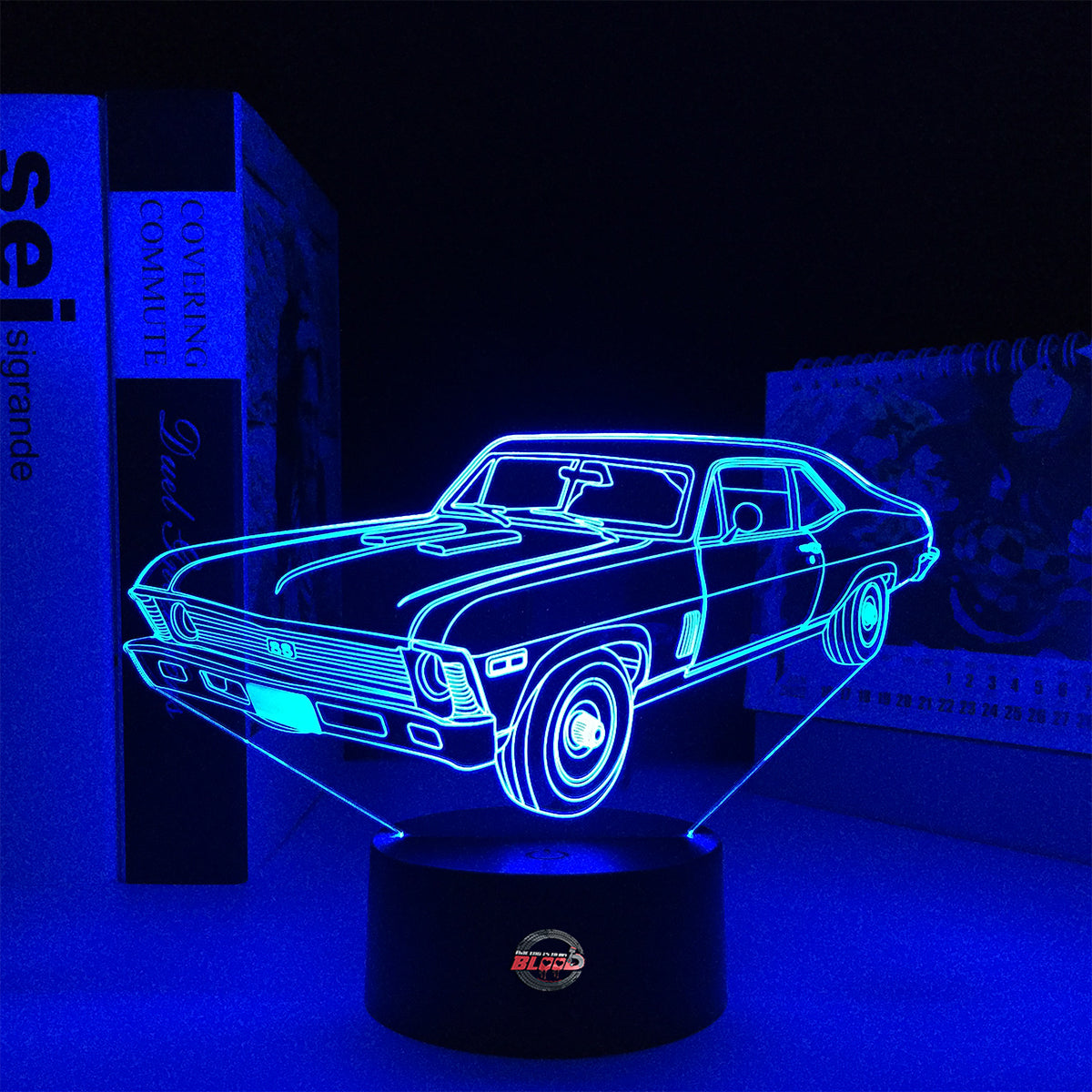 Personalized 1969 Chevy Nova LED Lamp featuring a custom name and number on a glowing muscle car silhouette, shown in a vibrant orange on a black base.