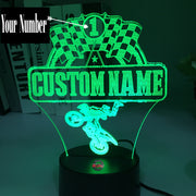 Personalized Motocross 3D LED Illusion Lamp featuring a custom name and racing number alongside a dirt bike rider silhouette, glowing in a vibrant orange on a black base.