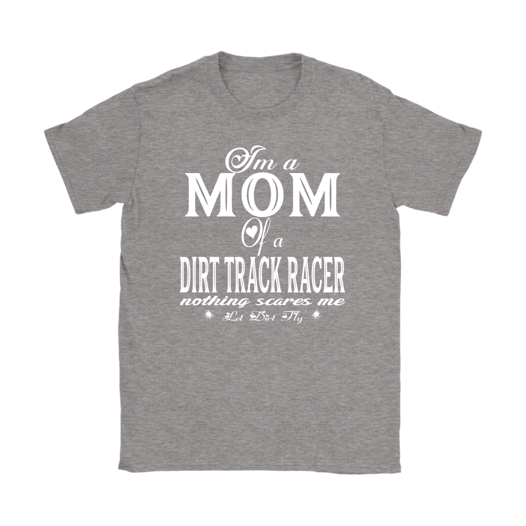 Premium black apparel mockup featuring a woman sitting on the wooden grandstand bleachers at a dirt track arena, wearing a soft custom t-shirt with a bold white graphic that reads "I'm a MOM of a DIRT TRACK RACER nothing scares me".
