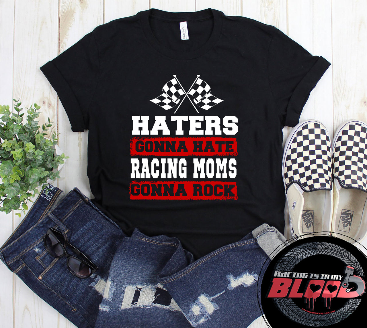 Premium black women's t-shirt mockup featuring a bold white and red graphic that reads "Haters Gonna Hate Racing Moms Gonna Rock" complete with crossed racing checkered flags.