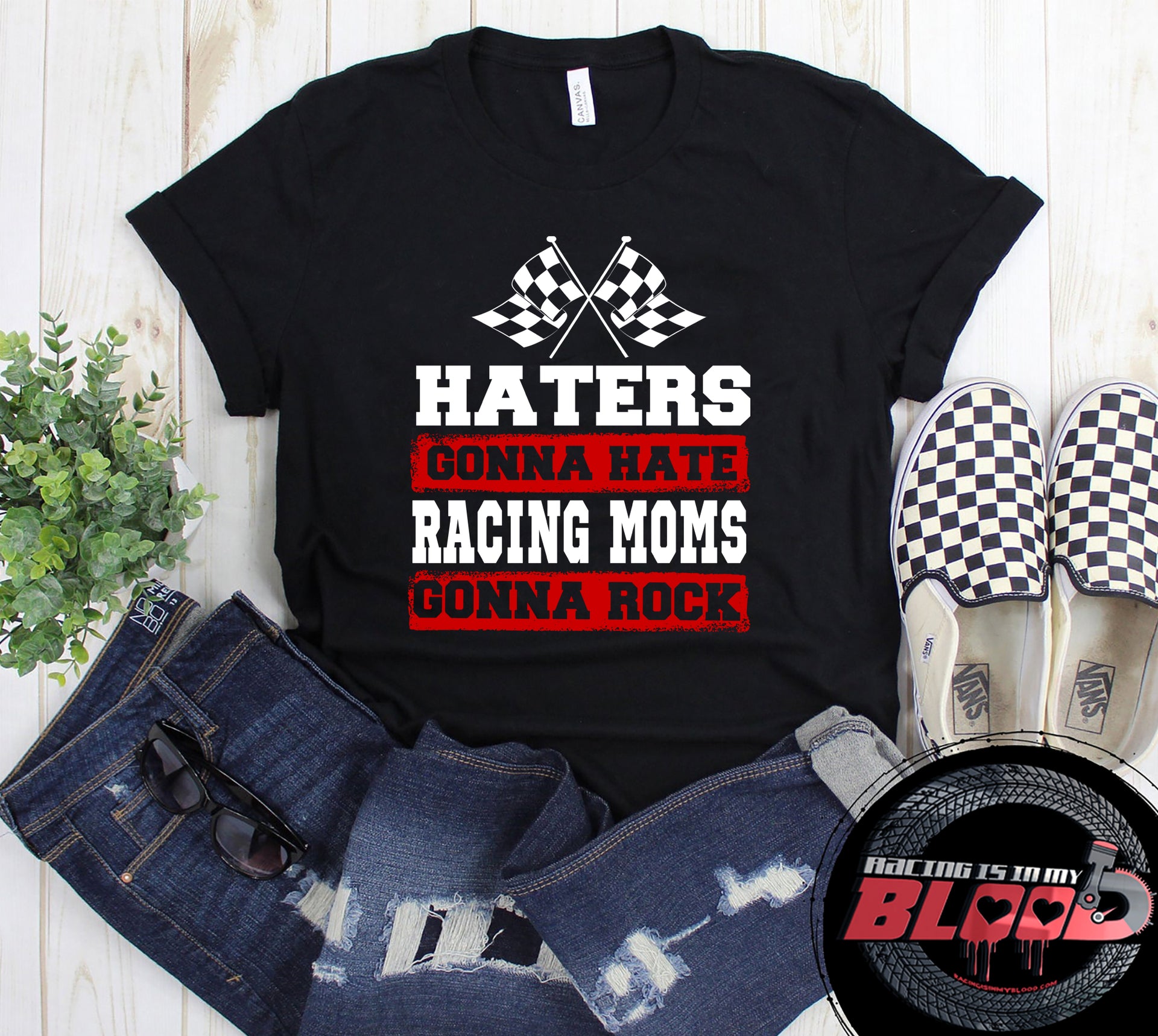 Premium black women's t-shirt mockup featuring a bold white and red graphic that reads "Haters Gonna Hate Racing Moms Gonna Rock" complete with crossed racing checkered flags.
