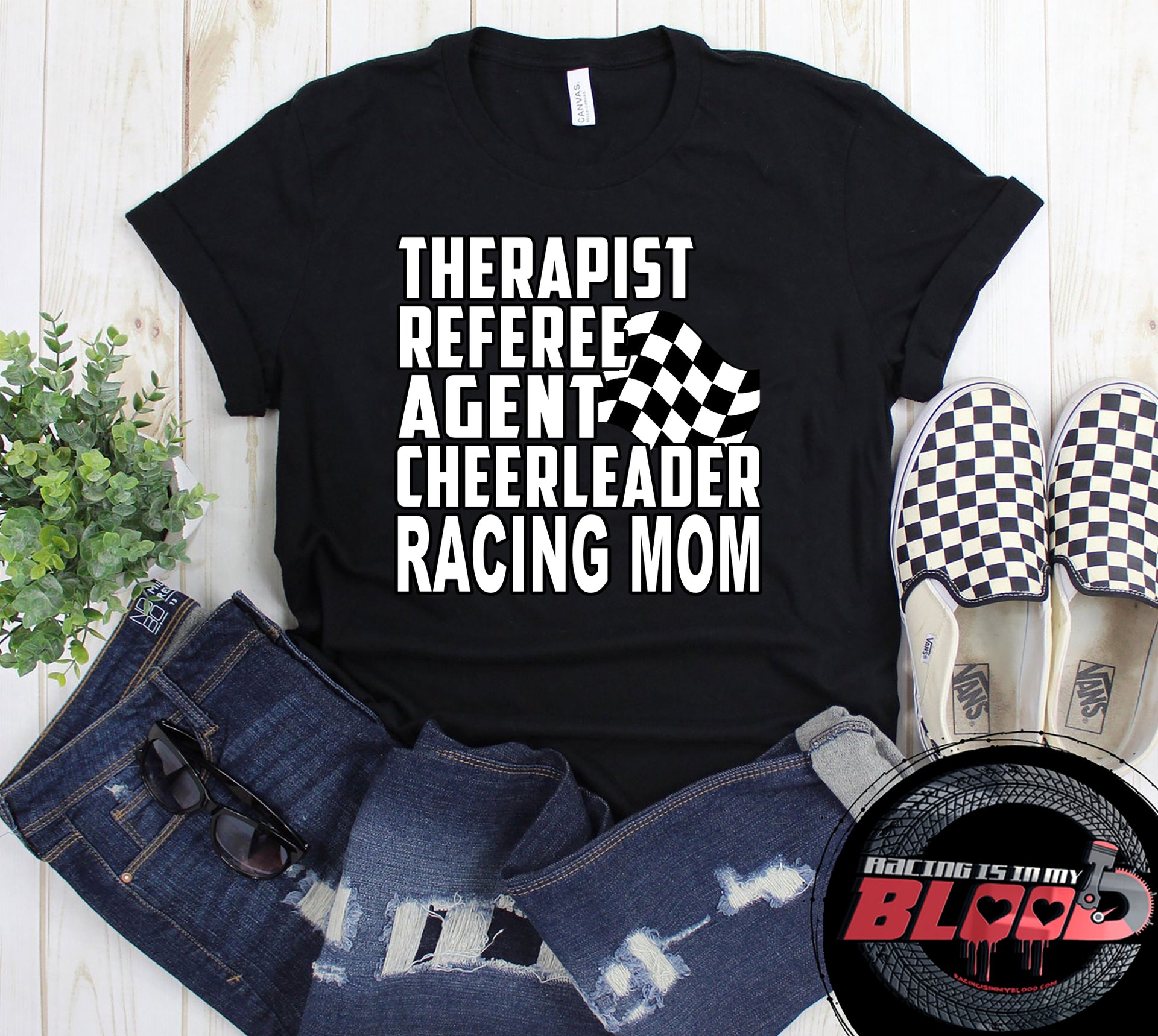 Premium black women's t-shirt mockup featuring a clean white graphic layout listing "THERAPIST REFEREE AGENT CHEERLEADER RACING MOM" paired with a classic checkered flag icon.