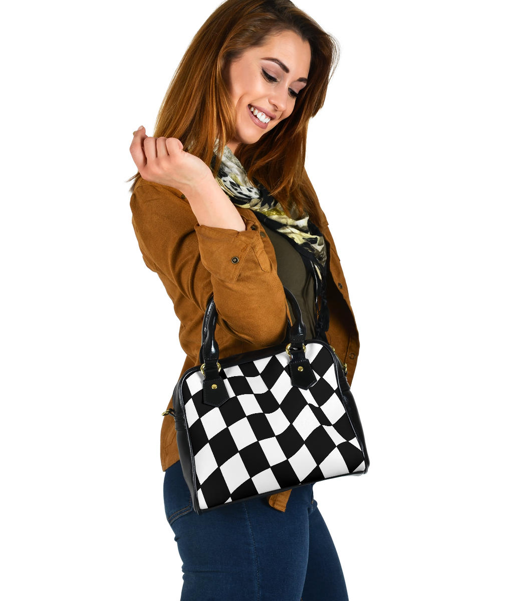 Premium leather shoulder handbag featuring an all-over racing checkered flag print with durable carrying straps and a removable shoulder strap.