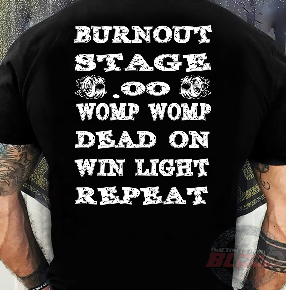 Premium motorsports apparel featuring the "Burnout Stage" design, available in various styles including soft-spun cotton tees and racerback tanks.